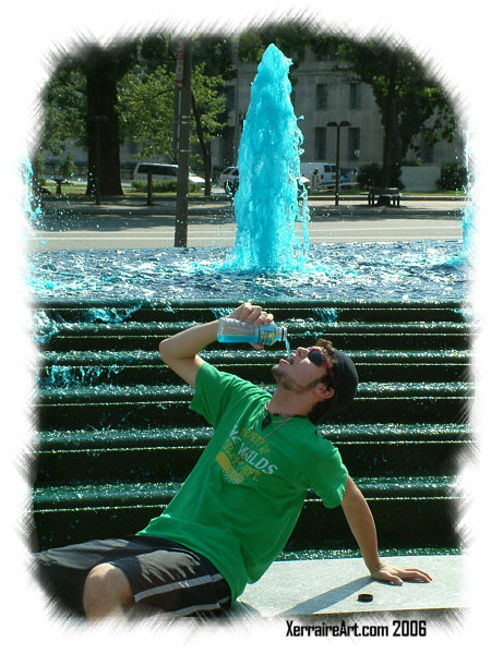 Miquel with the blue powerade in front of the blue water fountain